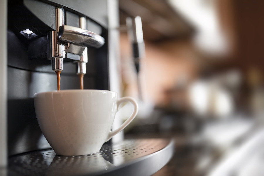 Coffee Pouring into a White Mug From a Two Prong Coffee Maker
