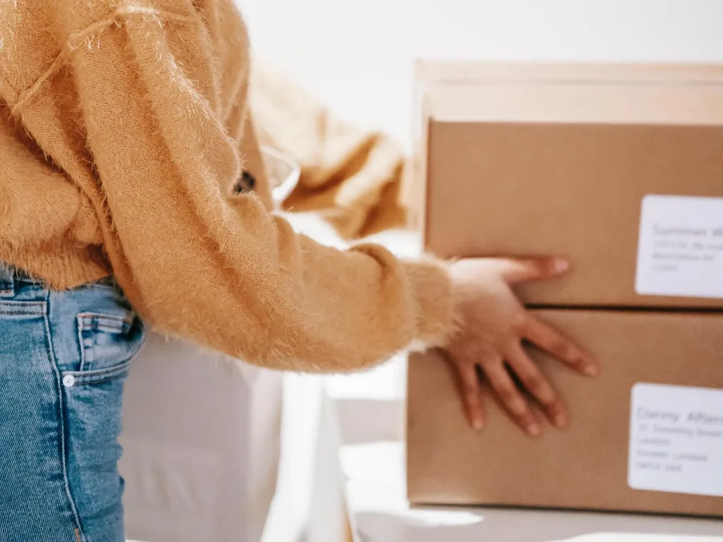 person holding parcel boxes