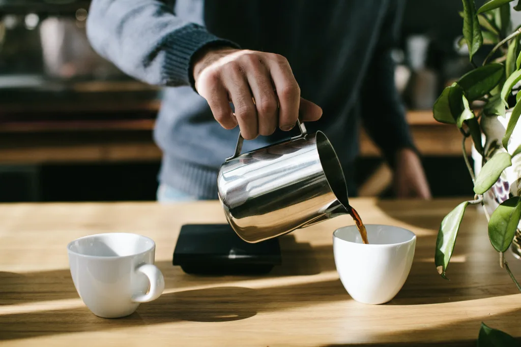man pouring coffee in an office